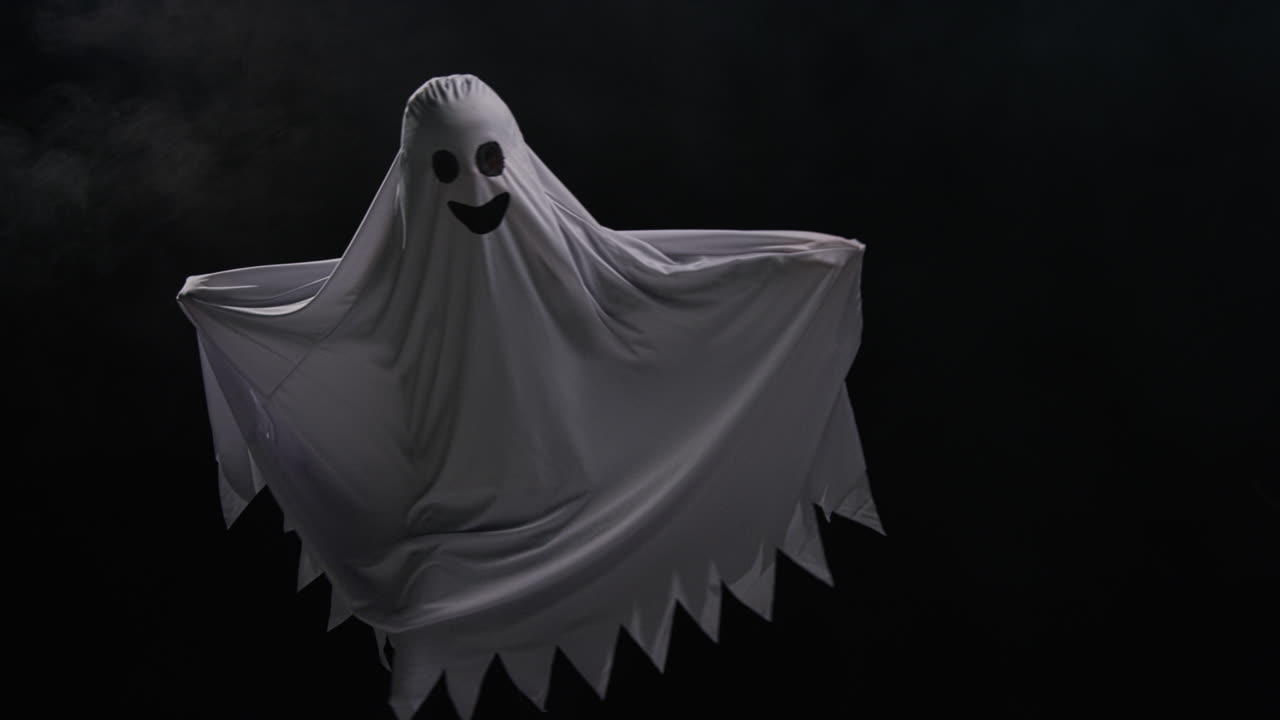 Child Dressed Up In Ghost Costume Trick Or Treating At Halloween Scaring People Running Around Against Black Background 1