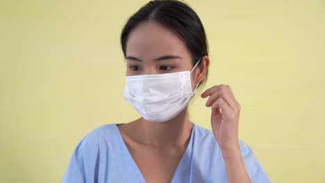 young asian woman take off face mask removing from face