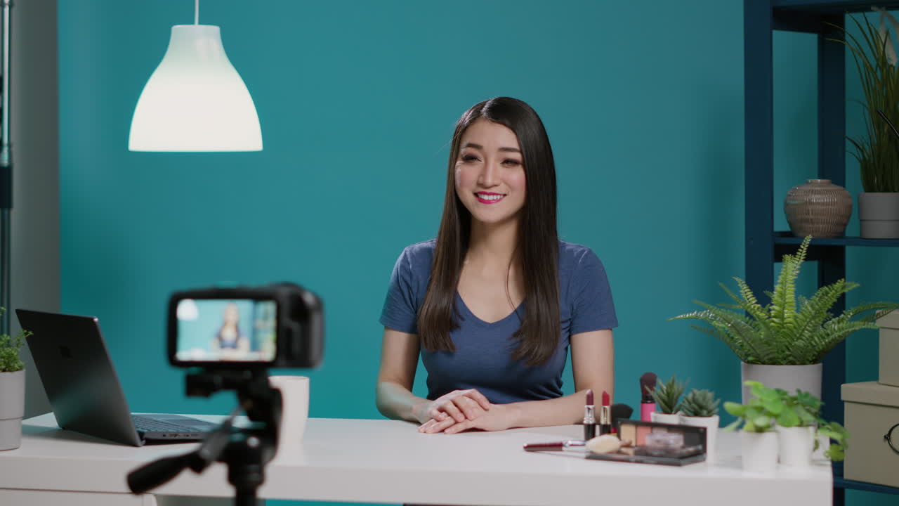 Female blogger recording beauty videoblog with cosmetics