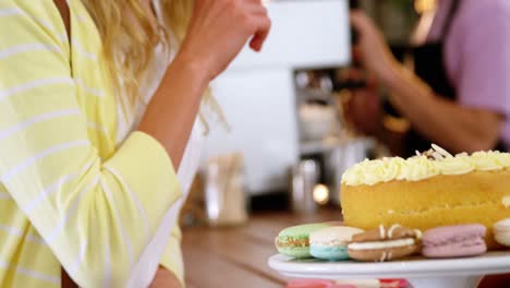 Smiling-woman-looking-at-desserts