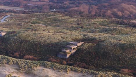 old abandoned world war two bunkers in atlantikwall hillside - aerial parallax