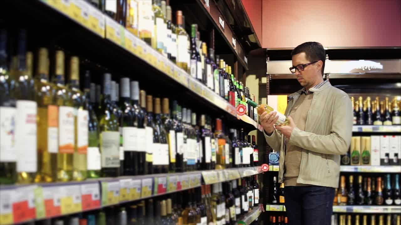 Man choosing wine in a grocery store