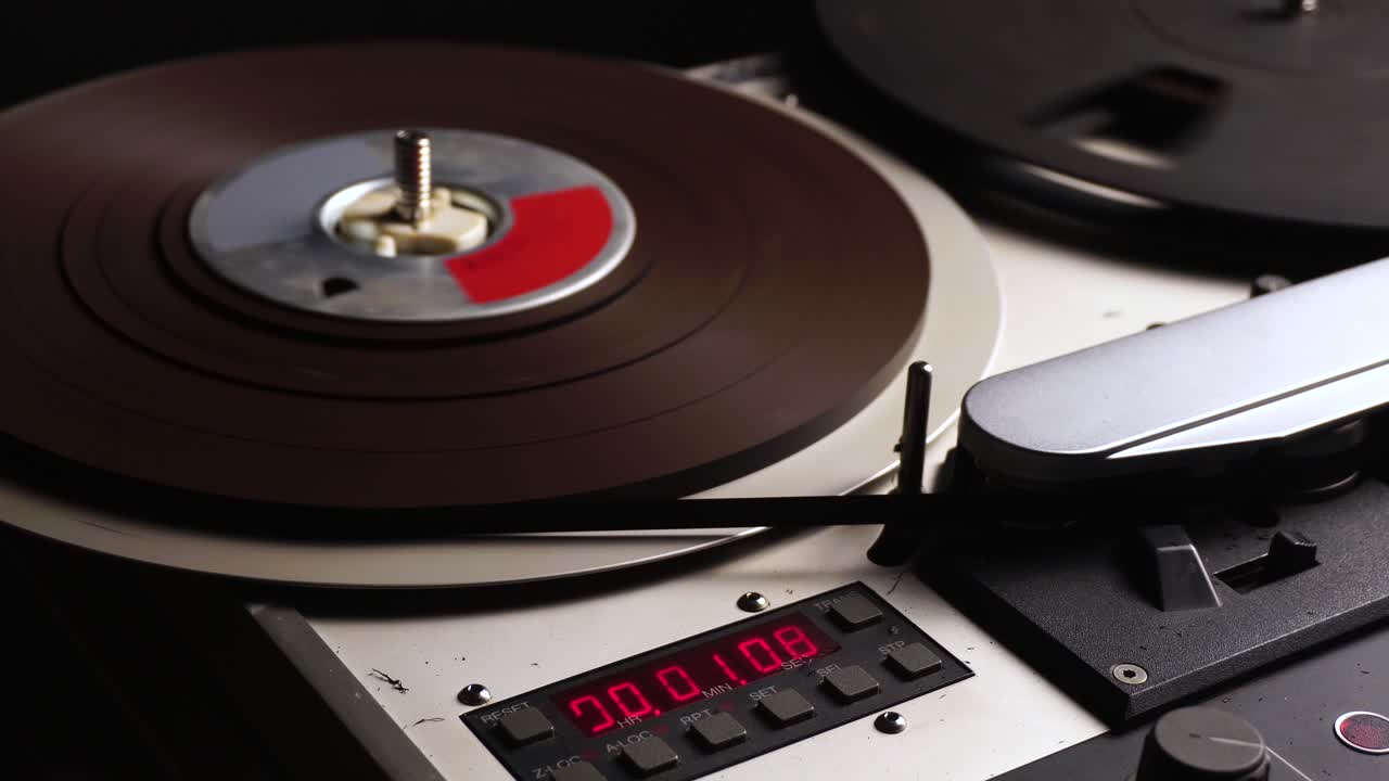 Close-up of a vintage reel-to-reel tape recorder with digital counter