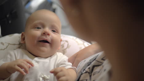 smiling baby girl looking at mother