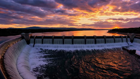 dramatic sunset over a hydroelectric dam
