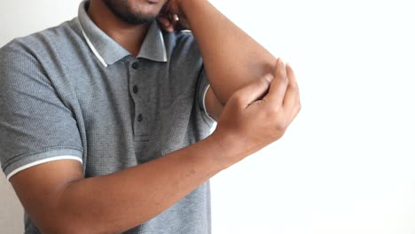 man checking his elbow