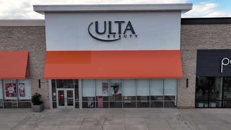 rising drone shot of ulta beauty store in america shopping center. suburb district with clouds at sky. wide shot.