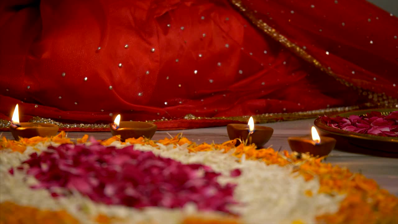 Diwali decoration - Indian women decorating her house with diyas and rangoli