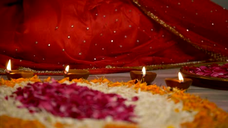 diwali decoration - indian women decorating her house with diyas and rangoli