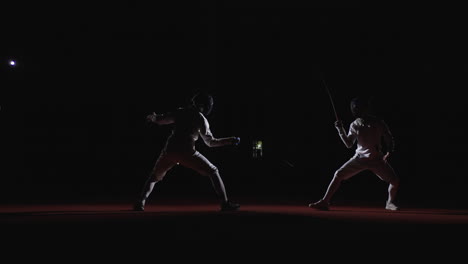 two fencers in action during a fencing competition