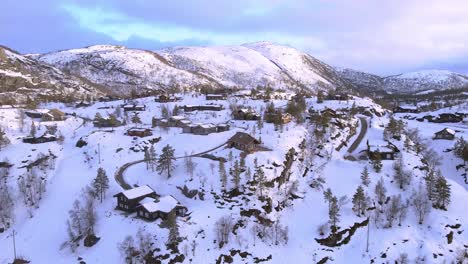 norwegian panorama drone shot of norwegian cabins next to ski resort