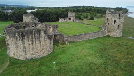 Flint-castle-Welsh-medieval-coastal-military-fortress-ruin-aerial-view-slow-right-orbit-shot