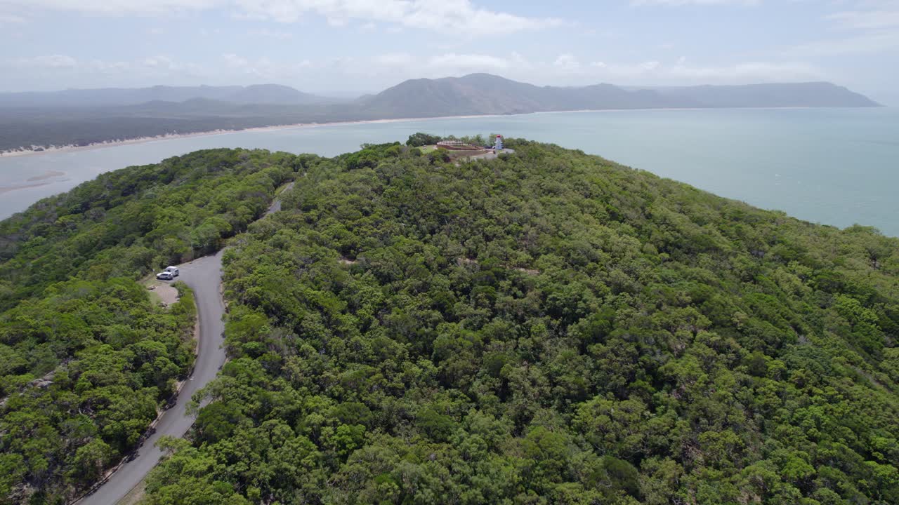 vista aérea de la carretera hacia el mirador de la colina cubierta de hierba y el faro en cooktown, queensland, australia