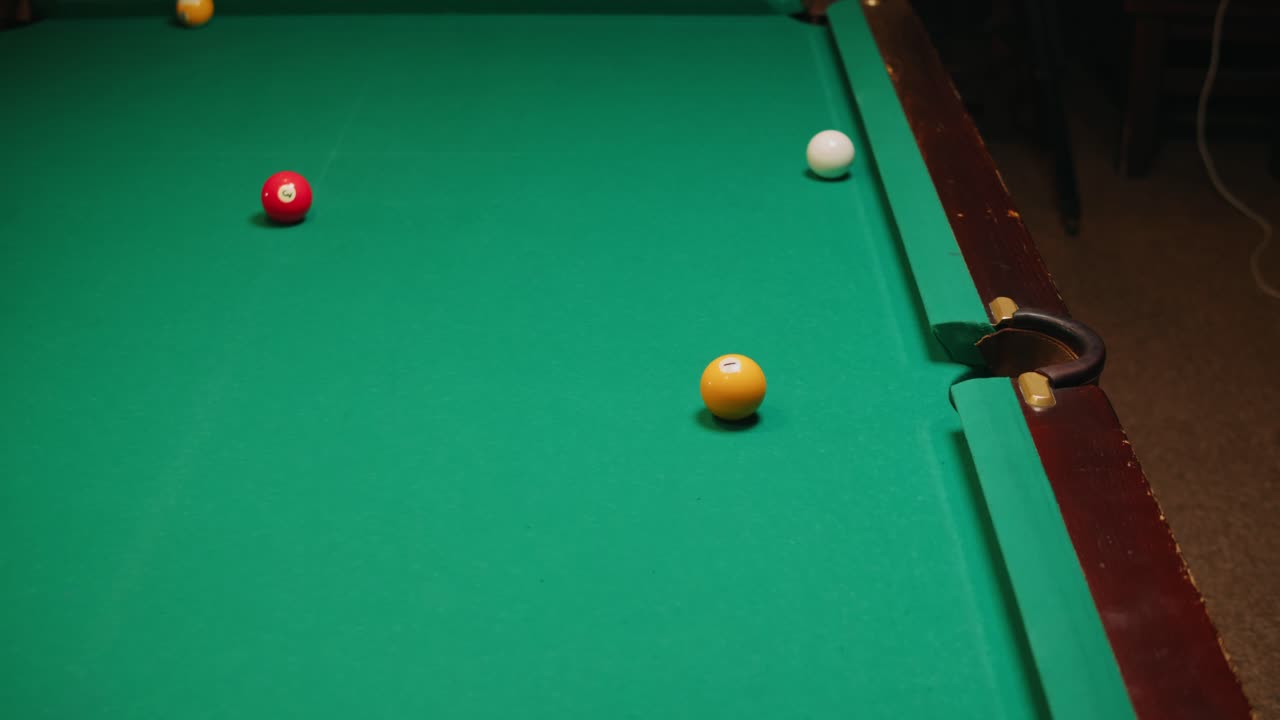 Playing American billiard poule close-up. Colorful balls on green billiards table .Billiard balls with numbers on a pool table. Billiards team sport. High quality 4k footage