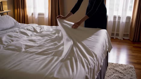 making a bed in a hotel room