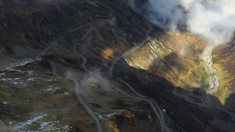 wide downward angle drone footage tilting up on the susten pass in the swiss alps in switzerland