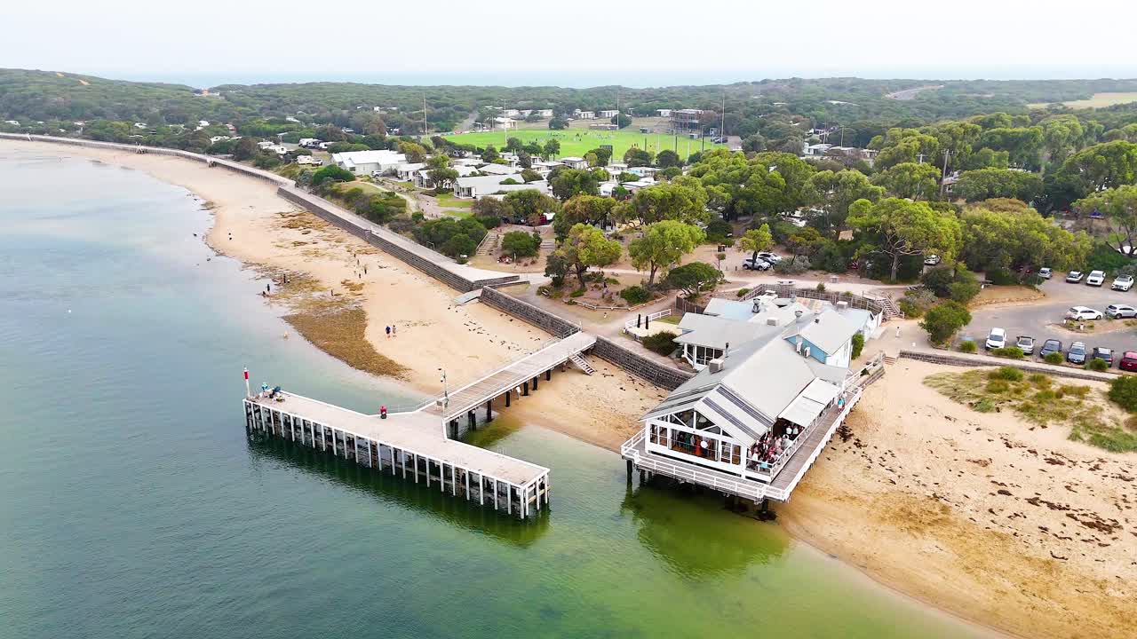 Drone footage captures Point Lonsdale's scenic pier and coastline under soft daylight, highlighting the tranquil coastal environment