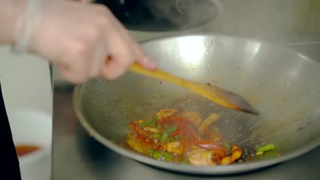 Cook-mixes-shrimps-with-vegetables-in-a-frying-pan-Then-he-separates-shrimp-from-vegetables