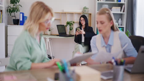 corporate employees discussing with boss nearby