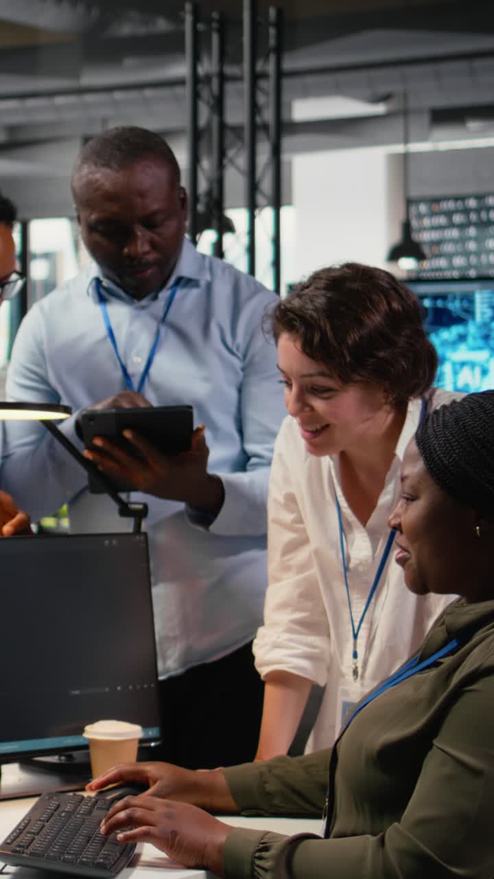 Vertical video Multiethnic technicians use devices in AI startup to train predictive models