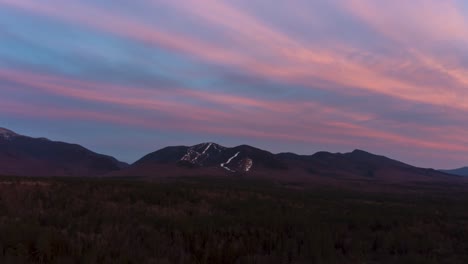 drone aerial time lapse of ski mountain sunset during spring summer with snow on trails 4k 30p