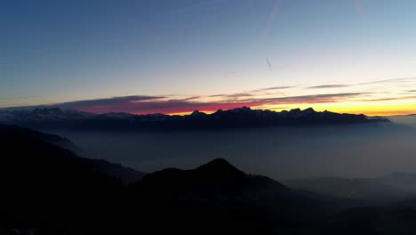 aerial shot of sunset over sea of fog, swiss alps in the background
snowy landscape