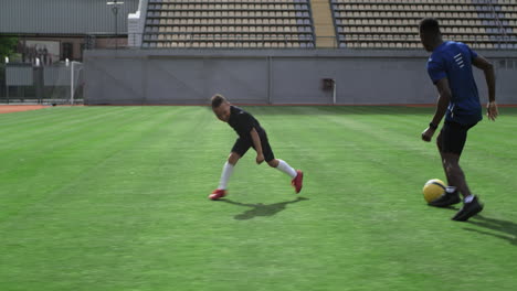 father and son playing soccer in a stadium