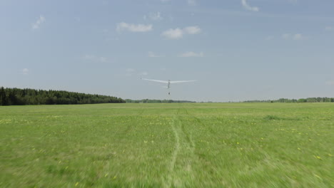 Glider-plane-taking-off-from-green-grass-runway