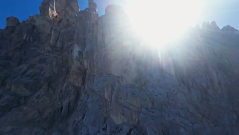 dramatic fpv drone flight over rocky mountain dolomite peaks in italy