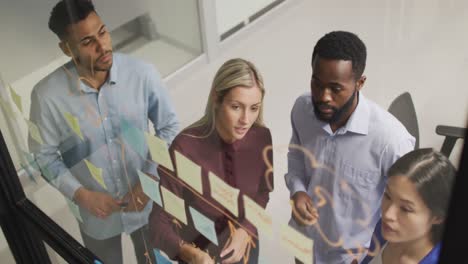 video of four diverse male and female colleagues brainstorming ideas together at night in office