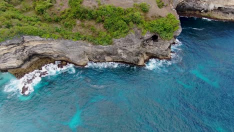 deep blue ocean with rocky cliffs in broken