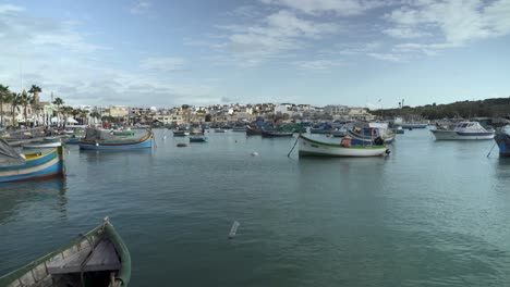 multi-coloured fishing boats in fishing village marsaxlokk in malta on winter day