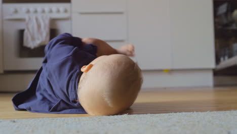 baby girl rolling on the floor at home