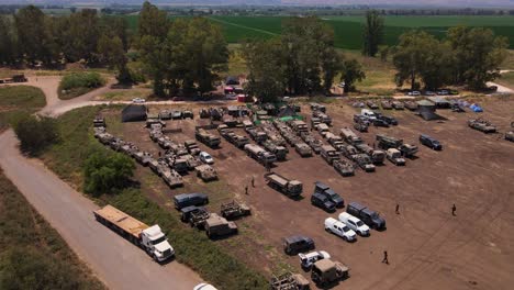 civilian trucks transporting idf battle tanks to field on gaza border