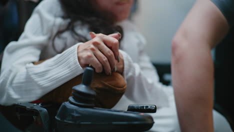 woman in wheelchair operating controls