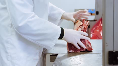 butcher arranging chopped red meat