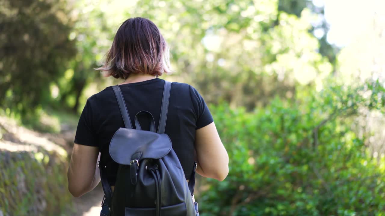 travel to cinque terre, girl hiking from one village to another village through the mountains of cinque terre.