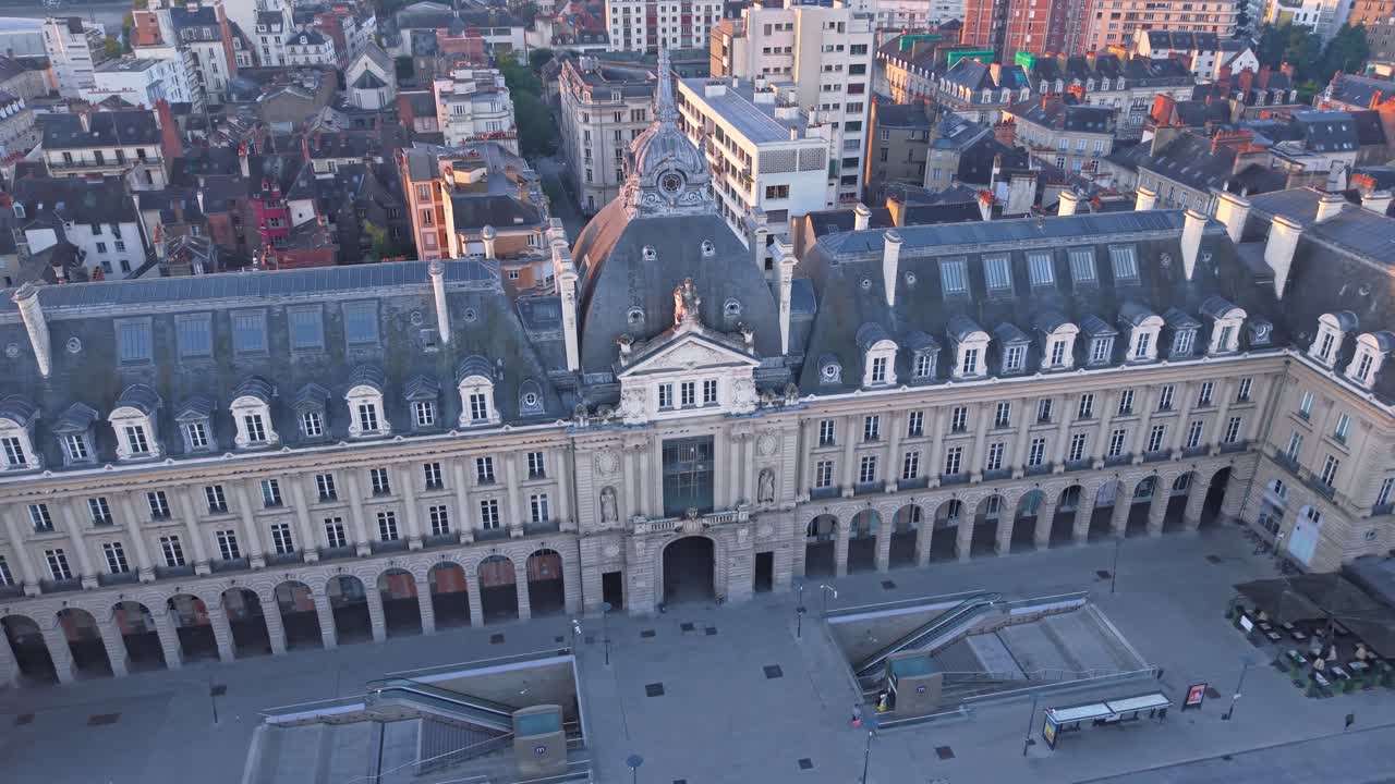 Place de la Republique and Palais du Commerce in Rennes, France at sunrise. Aerial drone circling