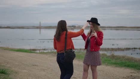 two women posing outdoors