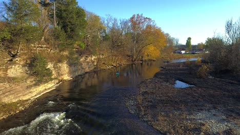 Aerial-of-person-in-canoe-on-creek-heading-toward-whitewater-section