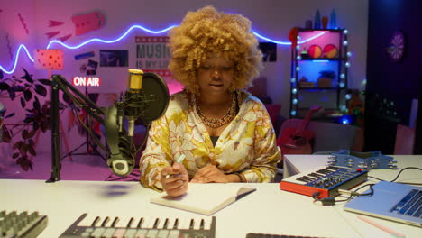 woman music producer in a colorful home recording studio