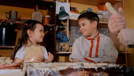 potter showing how to work with ceramic in pottery studio