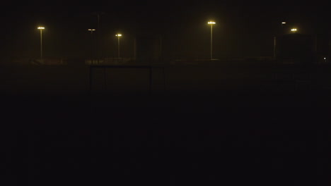 wide shot of a beach park at night in matosinhos , in an industrial area near the docks