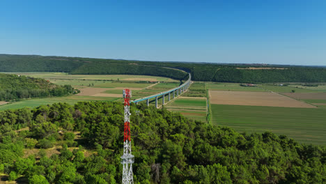 Aerial-ascending-shot-in-front-of-a-radio-tower-and-the-Mirna-bridge,-in-Croatia