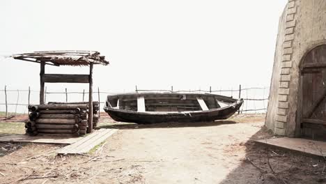 old wooden boat and well in a rustic setting