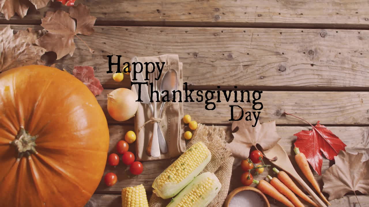 Animation of happy thanksgiving day text over autumn leaves and produce background