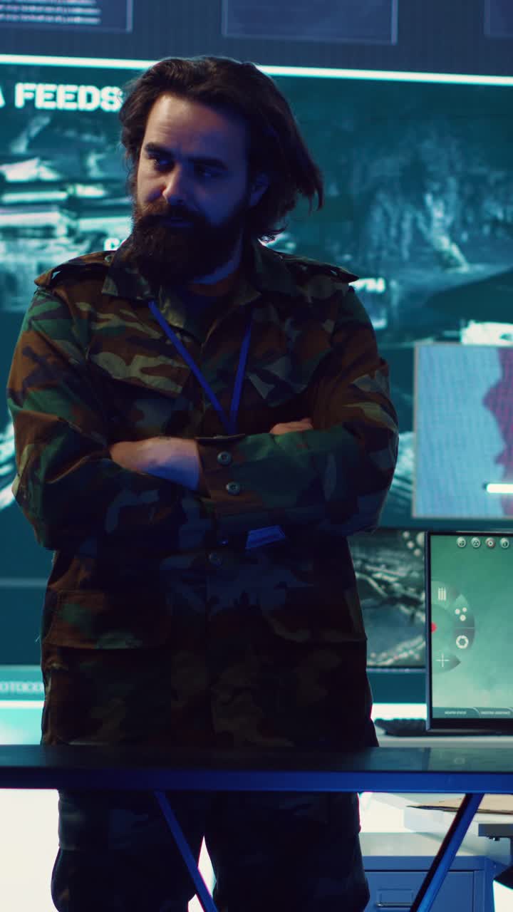 Man in Camouflage Uniform Standing in High-Tech Control Room