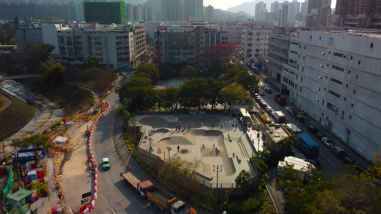 Tilting Up Dolly Push Out Drone Bird View over Skate Park. 4k Ariel footage showing Hong Kong skater BMX rider.