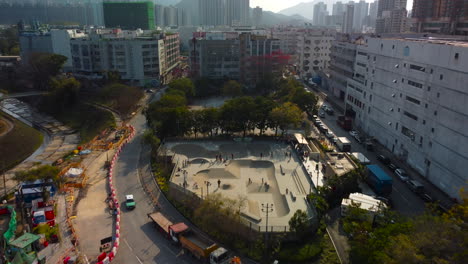 tilting up dolly push out drone bird view over skate park. 4k ariel footage showing hong kong skater bmx rider.