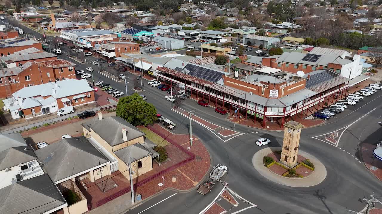 Urban traffic flows around clock tower in small Australian town